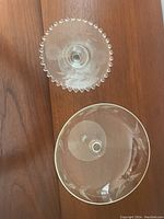 Top-down view of the etched glass stemmed bowl showing floral etching and scalloped beaded rim of serving plate.