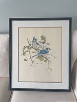 Front view of the professionally framed painting showing two blue jays on a branch.