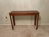 Front view of the solid wood hall table showing rectangular top and four wood legs