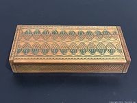 Top view showing leaf and geometric etched design on the wooden box lid.