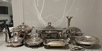 Full lot overview on countertop showing all silver-plated items