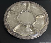 Top view of silver-tone Lazy Susan with 5 glass inserts displaying the starburst pattern.