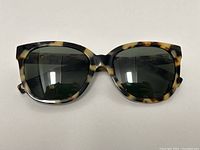 Front view of Warby Parker Reilly 195 sunglasses showing tortoiseshell frame and dark lenses
