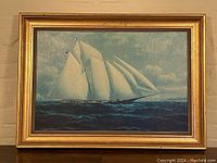 Full view of framed lithograph showing schooner sailing on choppy sea under cloudy sky