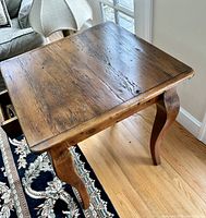 Wooden side table top with rustic, distressed finish and natural wood texture.