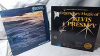 Photo showing both vinyl records side by side: Santana Moonflower and Elvis Presley The Legendary Magic.