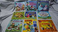 Photo showing all nine record and book sets arranged in three rows. Titles and colorful covers visible including Peter the Wolf, Mickey and the Beanstalk, Cinderella, Little Hiawatha, Aladdin, Dumbo, Peter Pan, Yogi Bear, and Bambi.