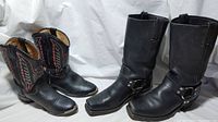 Pair of black men's biker style boots next to child's black cowboy boots with lizard print and decorative stitching