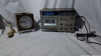 Photo showing RCA square wood-grain clock radio on left and General Electric AM/FM cassette tape radio on right.