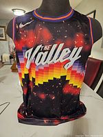 Front view of the Phoenix Suns basketball jersey with 'The Valley' and rainbow pixel design.