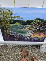 Full front view of painting showing the coastal landscape with water, trees, rocks, and hills under a blue sky with flying birds.