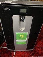 Front view of black and silver Commercial Cool portable air conditioner showing control panel and branding.