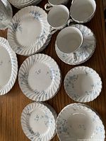 Top view of plates, bowls, cups showing blue floral ironstone pattern