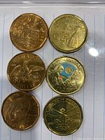 Photo of six Canadian one dollar coins with commemorative designs including Stanley Cup, Grey Cup, Montreal Canadiens, and standard loonies