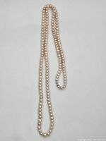 Full-length view of necklace laid flat showing entire strand