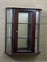 front view of curio cabinet showing door and shelves