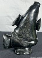Front view of polished black soapstone dancing bear statue in upright pose