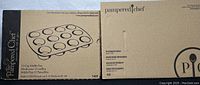 Boxes of Pampered Chef 12-cup muffin pan and rectangular baker showing brand and product type.