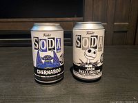 Front view of original unopened Funko Soda cans for Chernabog and Jack Skellington figures.