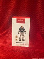 Photo of the front of the Hallmark Keepsake ornament box showing Buzz Lightyear and Sox figures from Disney Pixar Lightyear