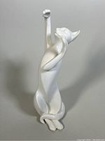 Front view of Royal Doulton cat figurine stretching with raised paws.