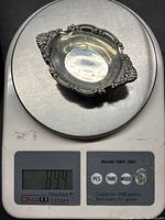 Single salt cellar weighed on digital scale showing 89.4 grams combined weight.