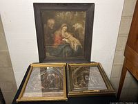 Three framed prints arranged with one larger Van Dyck print on top and two smaller framed prints below; frames show wear.