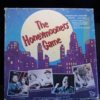 Box cover of The Honeymooners board game shows night cityscape with character photos and game title.