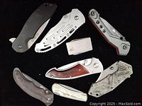 Image showing knives and lighter folded closed, highlighting handle styles and tool sizes.