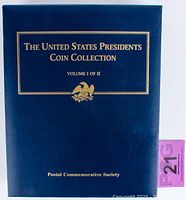 Blue binder titled 'The United States Presidents Coin Collection Volume I of II' by the Postal Commemorative Society