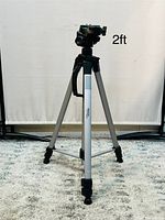 Camera tripod shown at 2 ft height with legs fully extended and central column down.
