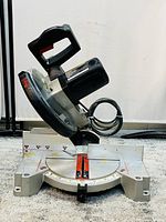 Front angled view of the Craftsman miter saw showing the base, handle, and blade guard.