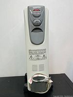 Front view of the DeLonghi Magnum oil-filled heater showcasing the control dial, brand labeling, base with wheels and power cord coiled around the handle.
