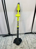 Front view of Ryobi ONE+ string weedeater showing yellow and black body and protective guard near cutting head.