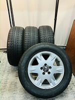 Front view of one wheel and tire in front of three others