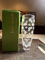 Front view of clear crystal vase with frosted polka dot pattern and Kate Spade green box beside it