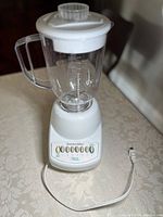 Full view of the Procter-Silex blender assembled on a table, showing the base with control panel and the 6 cup clear pitcher with lid.