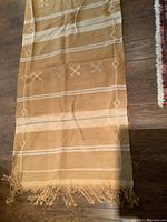 Fringe edge end of handmade runner carpet with visible weave and pattern.