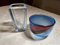 Photo showing both the small etched crystal vase and the blue art glass bowl placed side by side on a table.