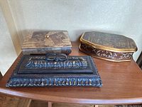 Photo showing all three jewelry boxes on a wooden surface illustrating size and style differences