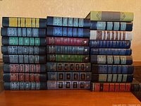 Full view of all 27 Reader's Digest Condensed Books stacked in 4 rows showing the various bindings and colors.
