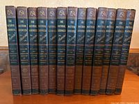 13 hardcover volumes of The Natural Sciences Illustrated lined up side by side, spines showing title, volume number, and editor credit to American Museum of Natural History