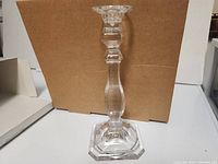 Single Mikasa Ambassador clear crystal candleholder with square base, shown outside of box.