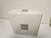 White Mikasa branded box containing the candle holders
