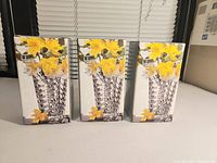 Front view of the three boxed Mikasa vases with yellow floral design on box showing the product image and branding.
