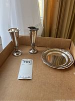 Lot overview with two silver vases and serving plate on cardboard background