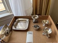 All six pieces arranged in cardboard box