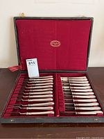 Full set of twelve oyster forks in open fitted case