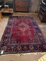 Full view of the oriental style rug laid out on floor showing overall design and colors.