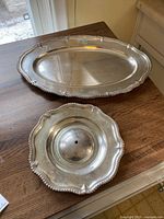 Oval and round platters displayed on wooden table